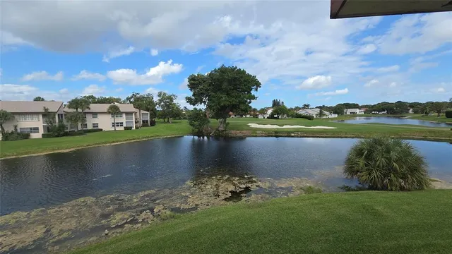 a view of a lake with houses in the back