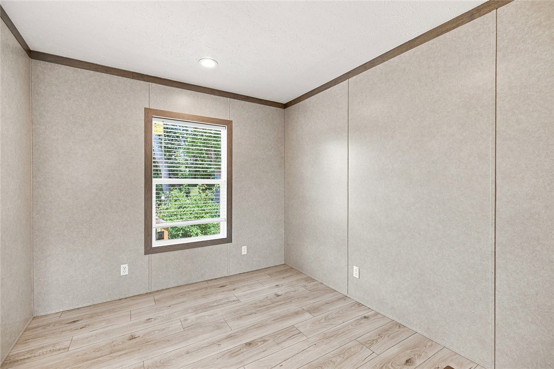 112 Purdy Road Iva, SC 29655 - Photo 22 of 33 Clean vinyl plank flooring pairs with wood-framed windows in this versatile room.