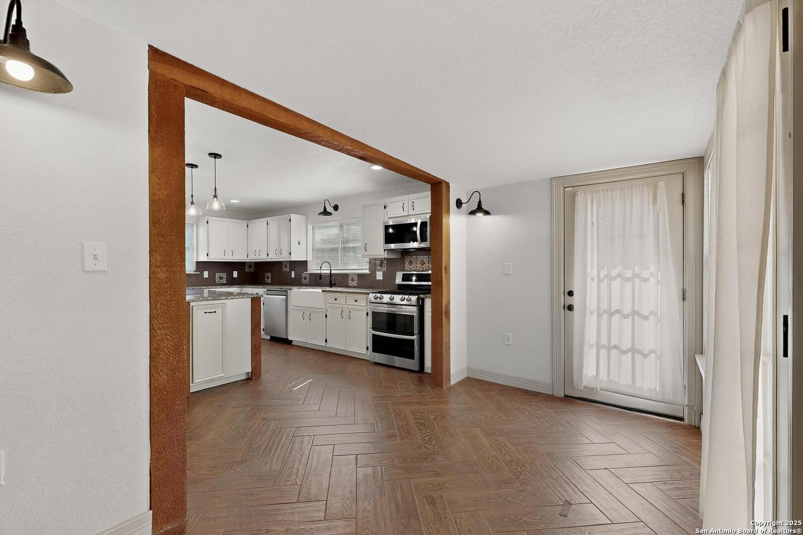 7140 Tree Bend Street China Grove, TX 78263 - Photo 14 of 49 a kitchen with stainless steel appliances and white cabinets