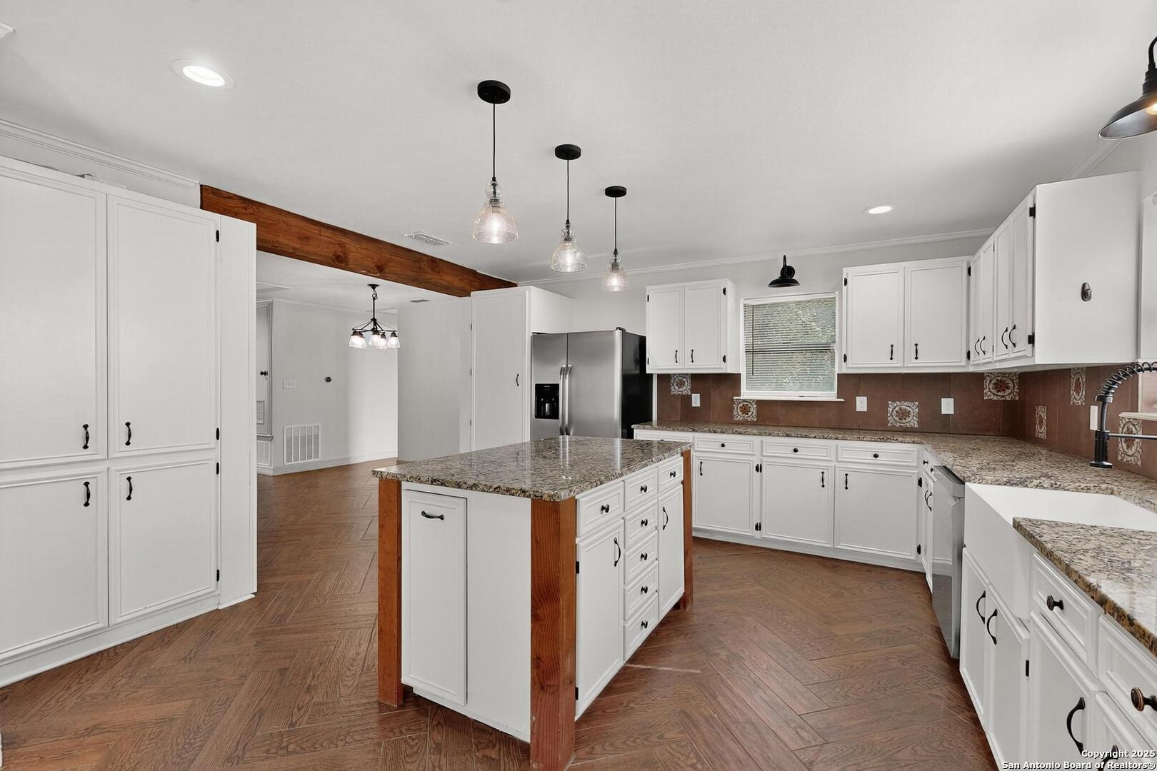 7140 Tree Bend Street China Grove, TX 78263 - Photo 16 of 49 a kitchen with stainless steel appliances kitchen island granite countertop a sink and cabinets