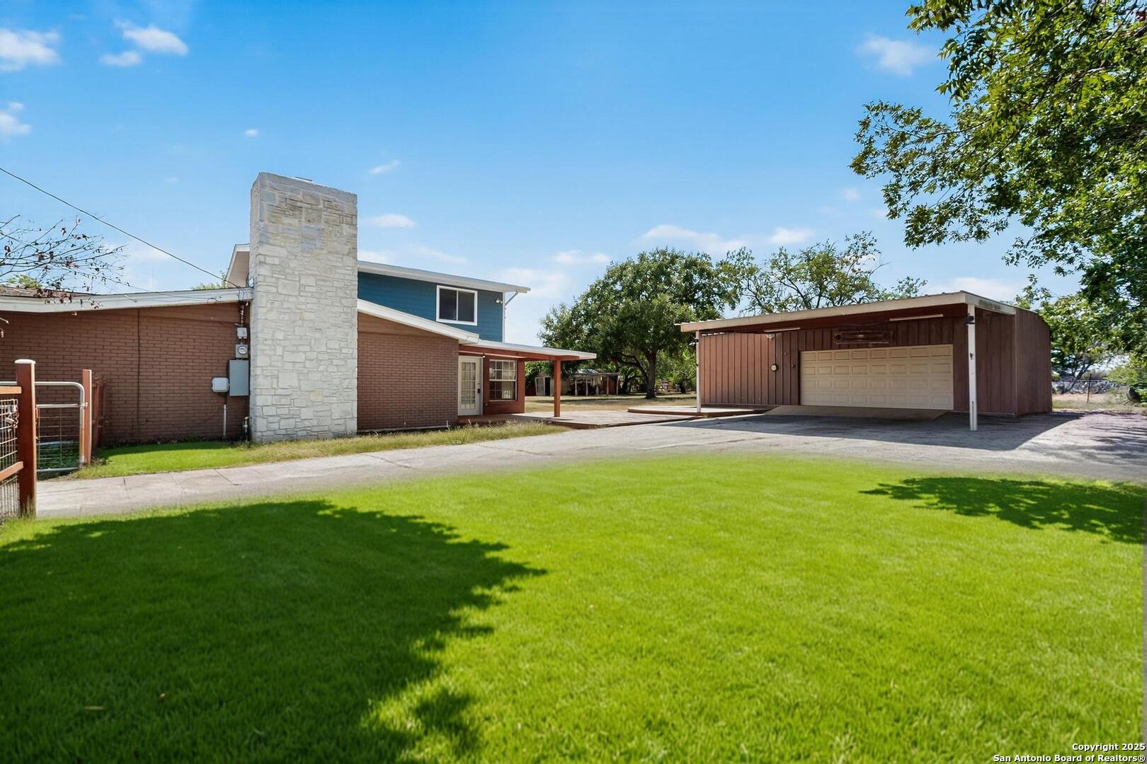 7140 Tree Bend Street China Grove, TX 78263 - Photo 47 of 49 a front view of a house with a garden and yard