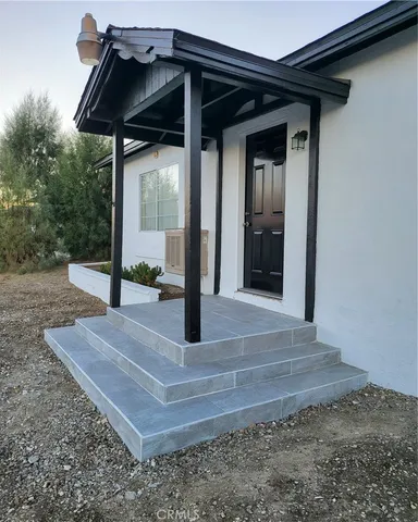an empty room with wooden floor and closet
