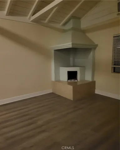 a kitchen with stainless steel appliances granite countertop a sink cabinets and wooden floor