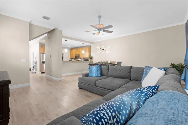 a living room with furniture and a chandelier