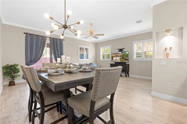 a view of a a dining room and a kitchen with a table chairs