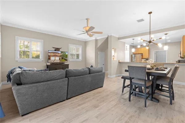 a living room with furniture and a chandelier