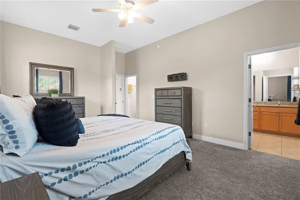 a bedroom with a bed and dresser