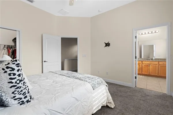 a bedroom with a bed and a chair