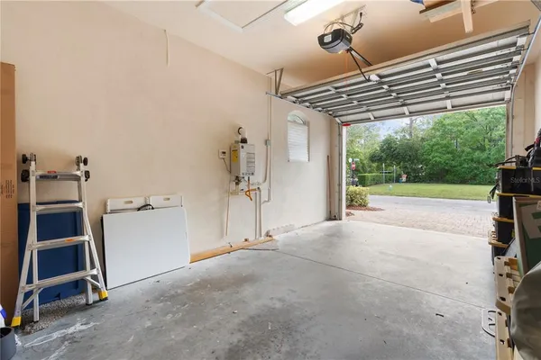 a view of an empty room with a windows and a ceiling fan