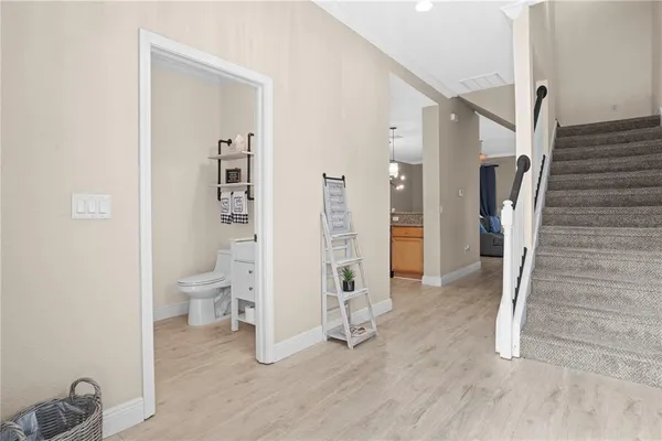 a view of entryway with wooden floor and a bathroom