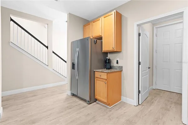 a view of kitchen with stainless steel appliances granite countertop cabinets and a counter top space