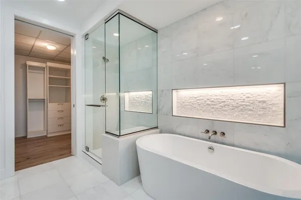 a bathroom with a bathtub and a shower