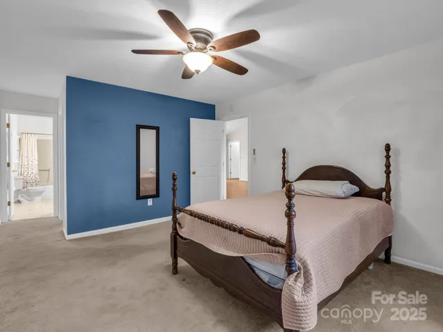 a bedroom with a bed and a ceiling fan