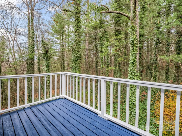a balcony with wooden floor and fence
