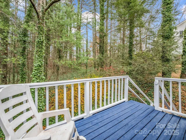 a view of balcony with wooden floor and fence