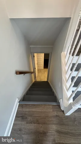 an empty room with wooden floor and a window