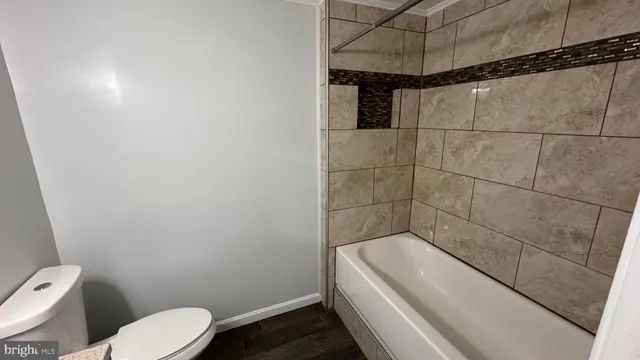 a living room with a fireplace furniture a rug and a window