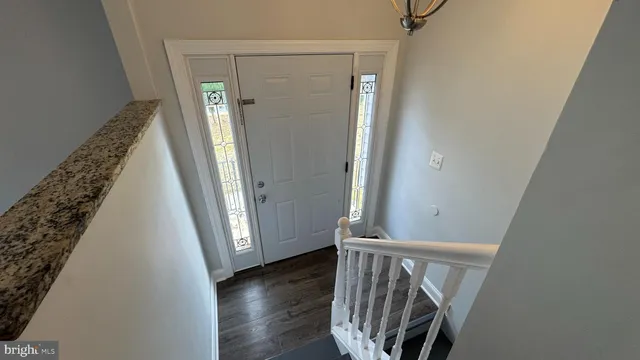 an empty room with wooden floor and a window