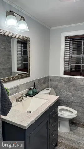 a bathroom with a granite countertop shower and a mirror