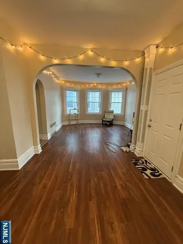 a view of a room with wooden floor and window