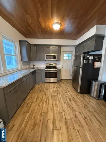 a kitchen with granite countertop a refrigerator and a stove