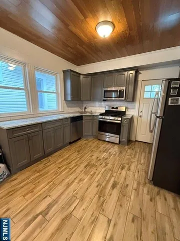 a kitchen with granite countertop a stove top oven and sink