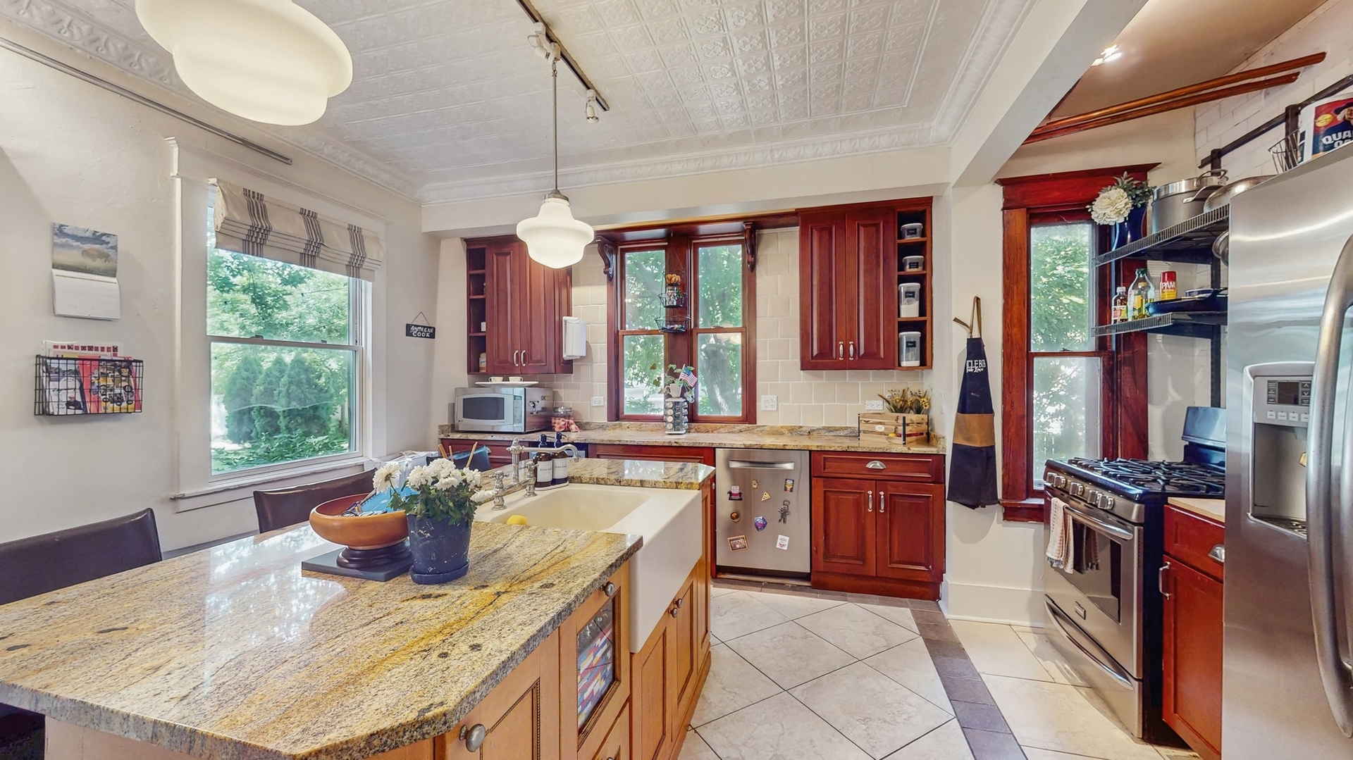 614 McCarthy Road Lemont, IL 60439 - Photo 7 of 37 a kitchen with stainless steel appliances granite countertop a stove a sink a microwave dining table and chairs