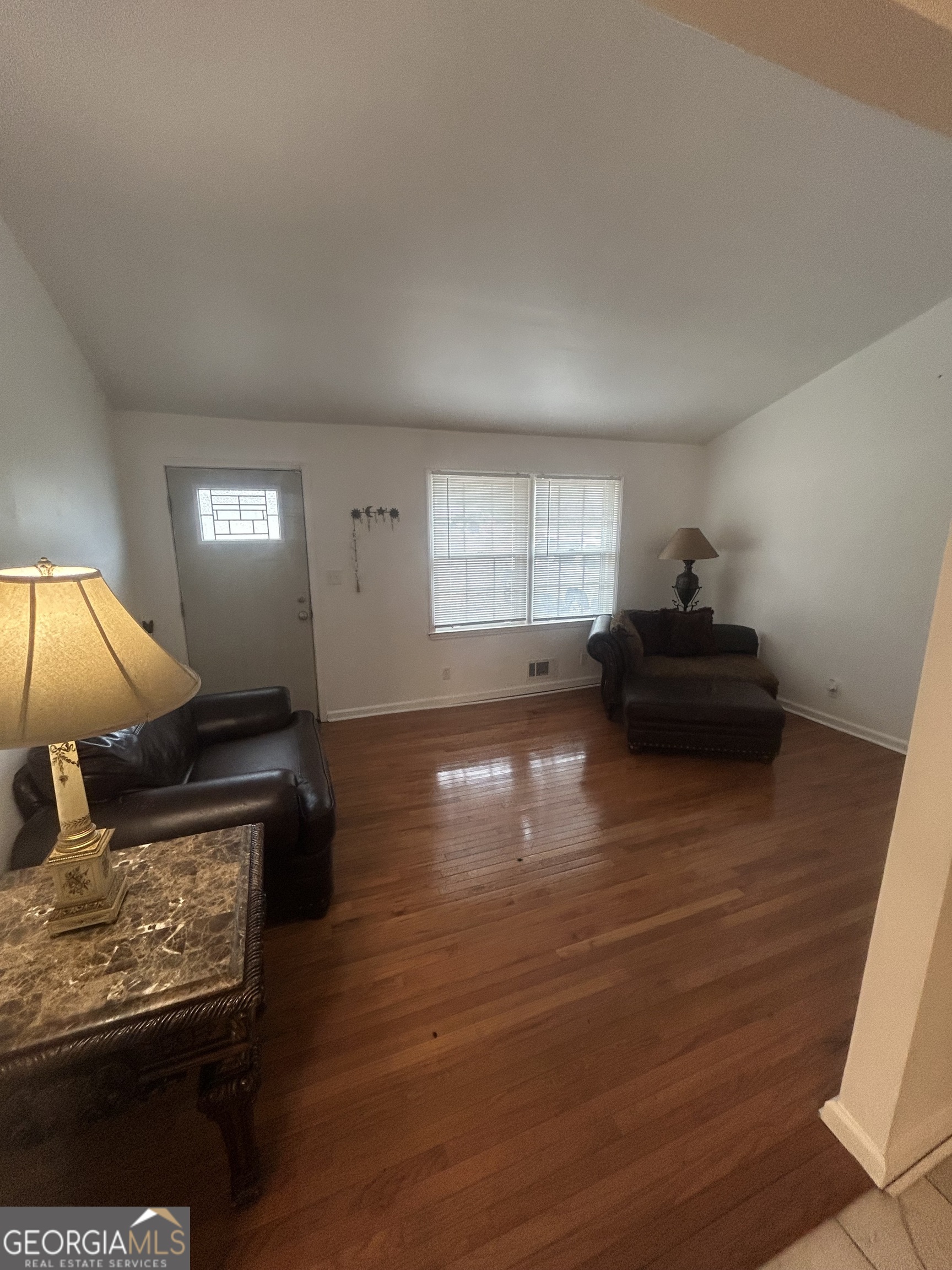 1406 Canterbury Road Griffin, GA 30223 - Photo 5 of 26 a living room with hard wood floors and a couch