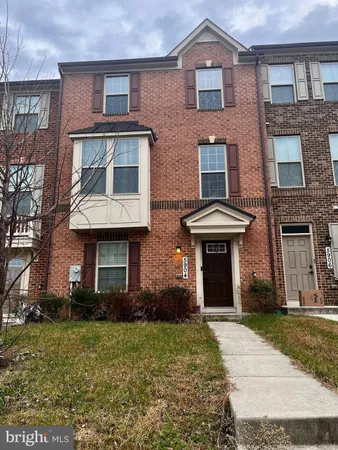 front view of a brick house with a yard