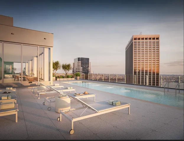a view of a livingroom with furniture and floor to ceiling window