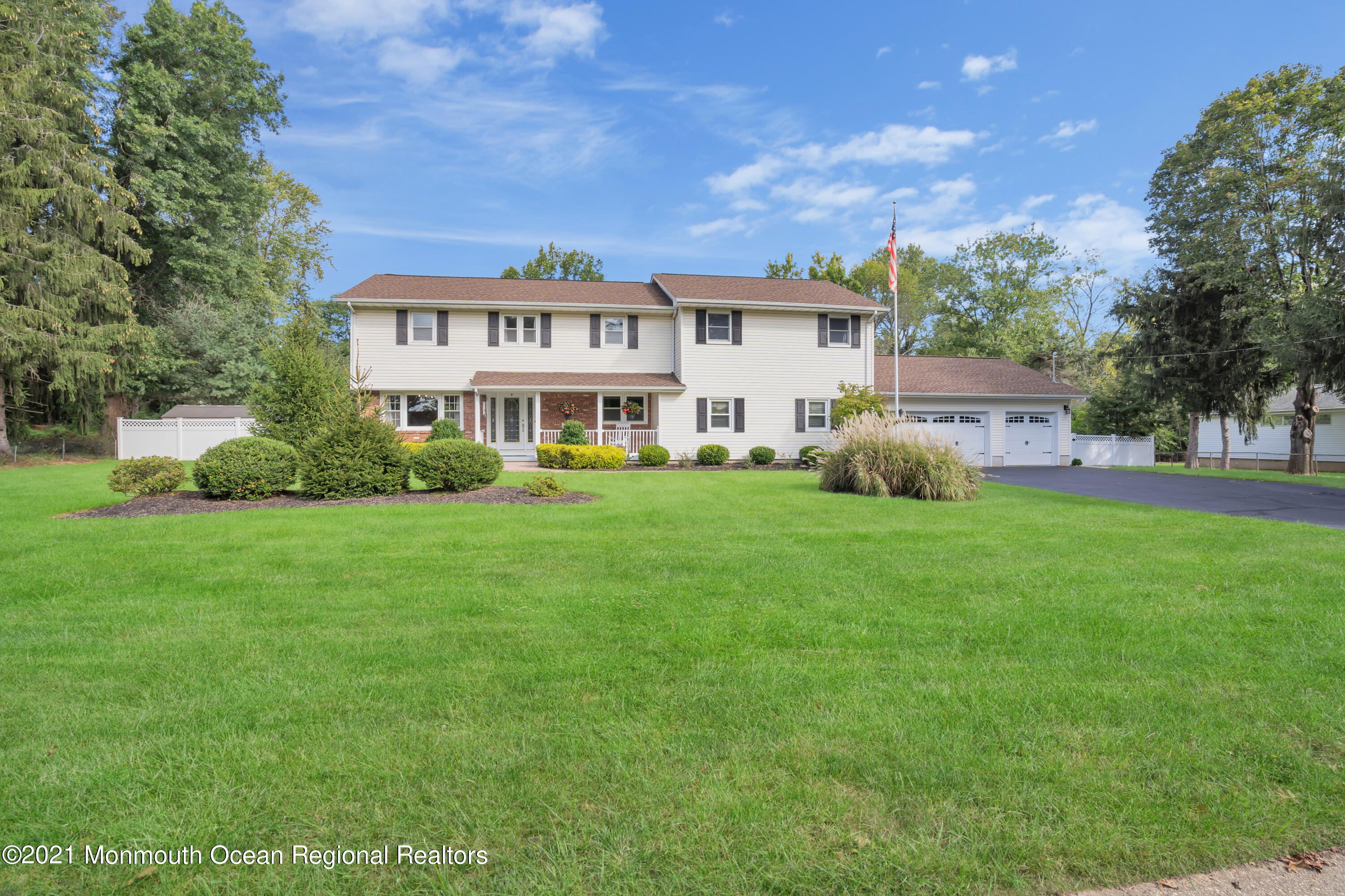 843 Nutswamp Road Red Bank, NJ 07701 - Photo 2 of 92 a front view of a house with garden and trees