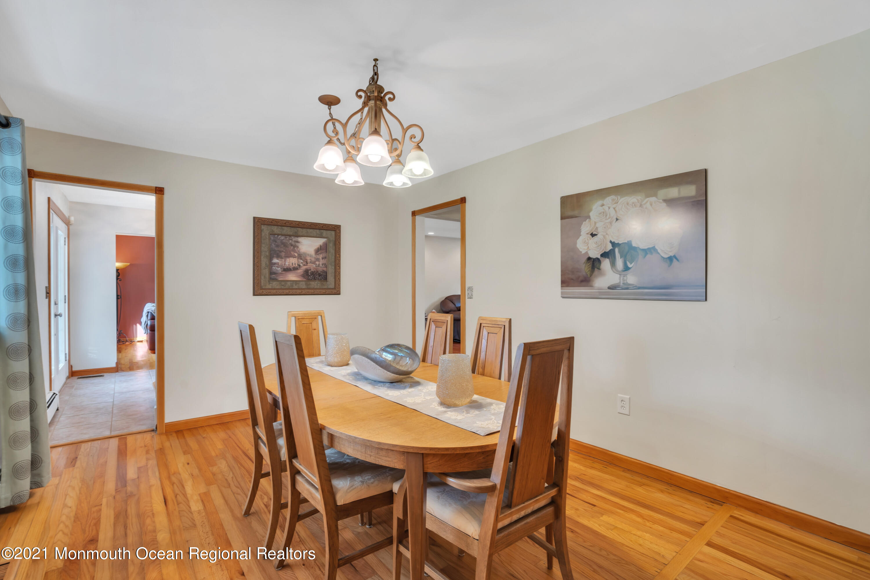 843 Nutswamp Road Red Bank, NJ 07701 - Photo 20 of 92 a view of a dining room with furniture wooden floor and a chandelier