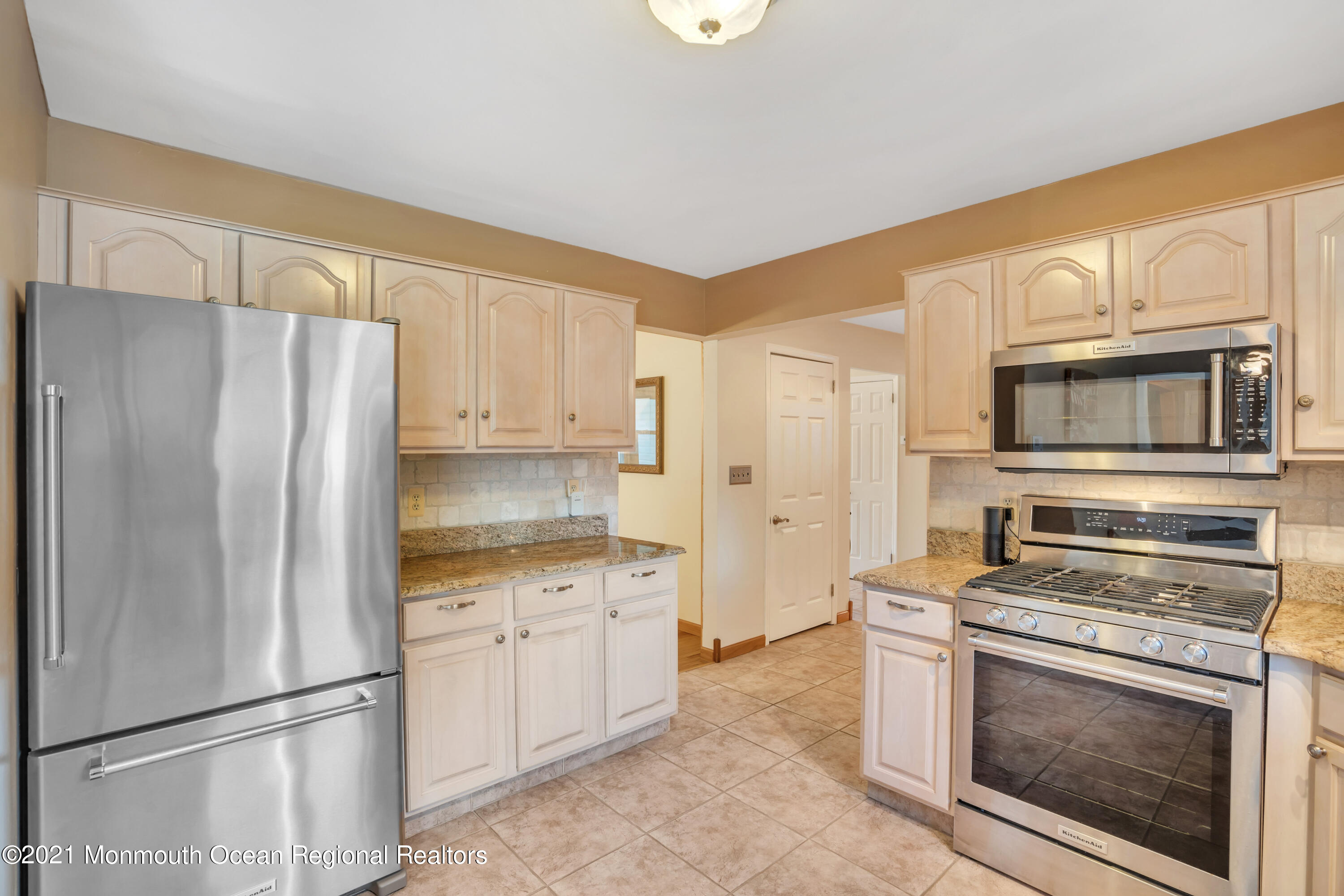 843 Nutswamp Road Red Bank, NJ 07701 - Photo 27 of 92 a kitchen with white cabinets and stainless steel appliances