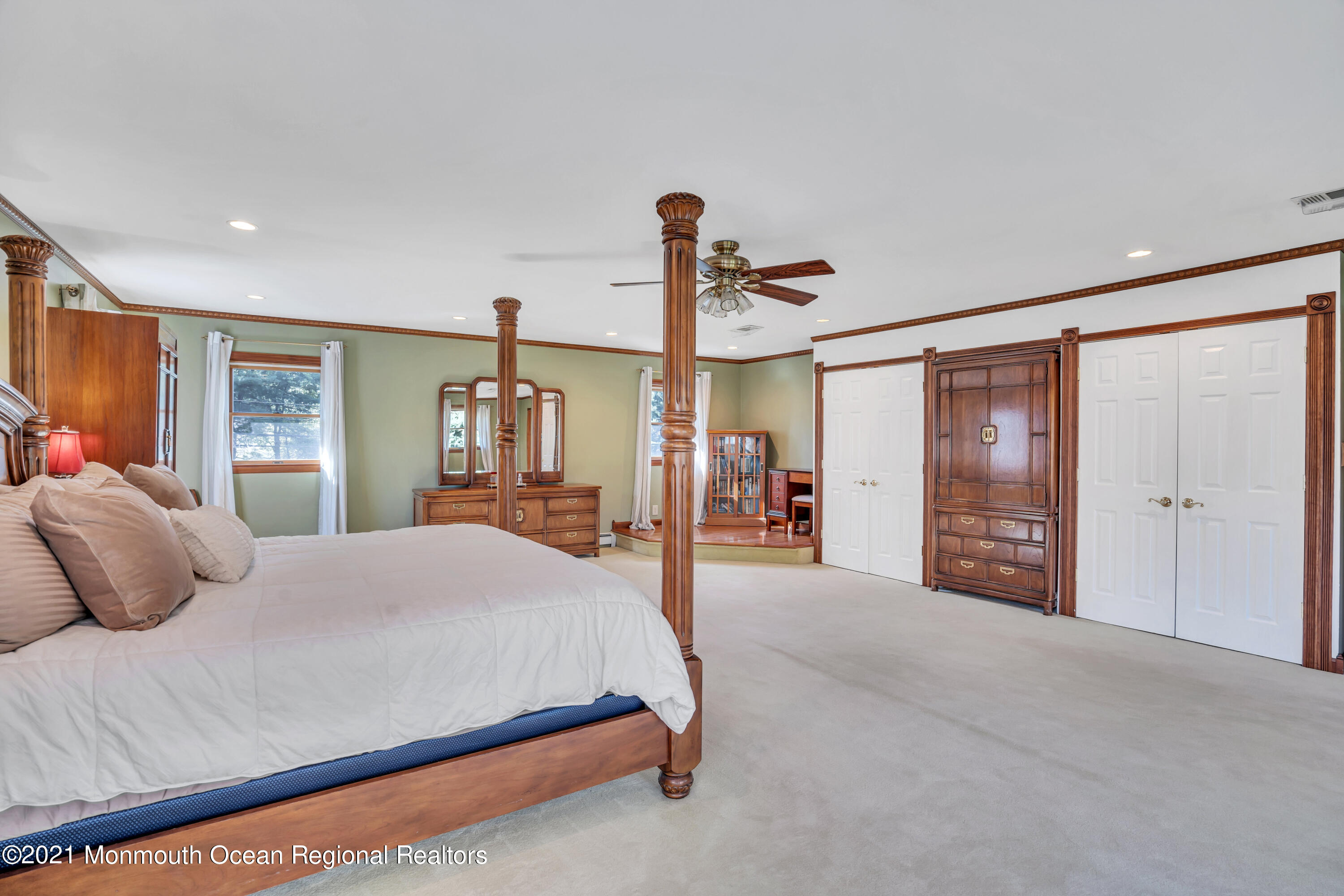 843 Nutswamp Road Red Bank, NJ 07701 - Photo 41 of 92 a bedroom with a large bed and a chandelier