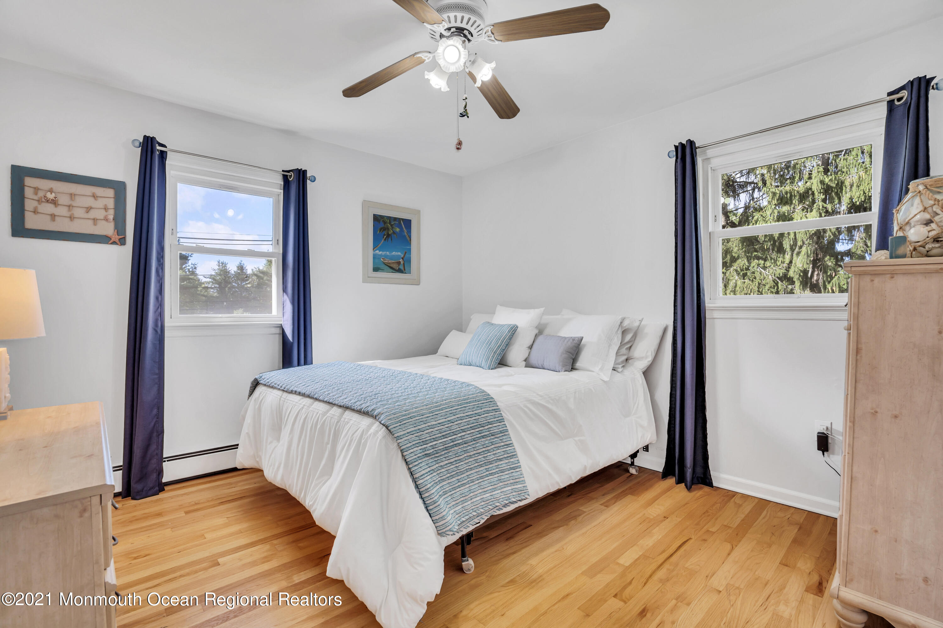 843 Nutswamp Road Red Bank, NJ 07701 - Photo 53 of 92 a bedroom with a large bed chandelier and a window