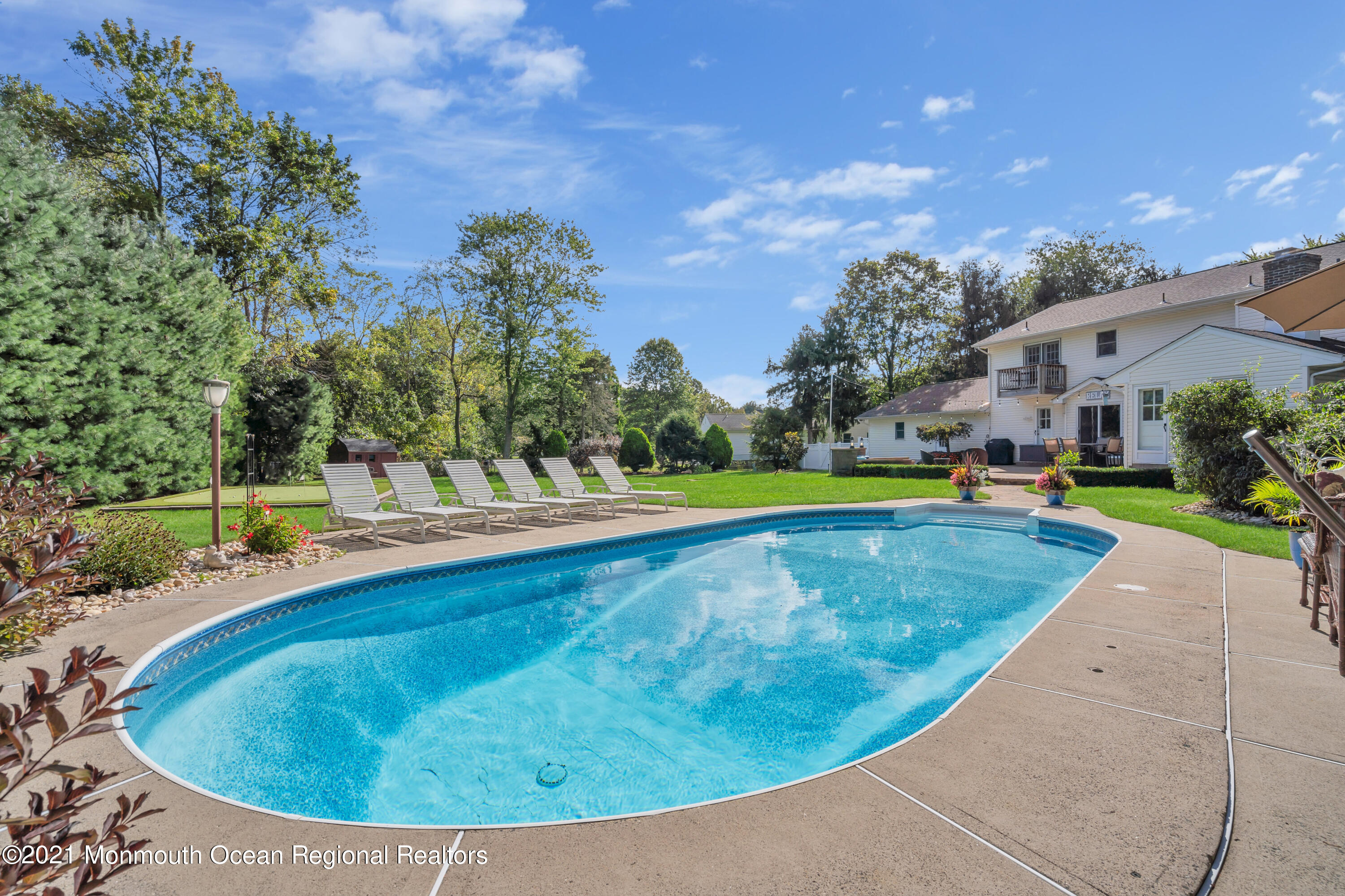 843 Nutswamp Road Red Bank, NJ 07701 - Photo 65 of 92 a view of a swimming pool with a yard and plants