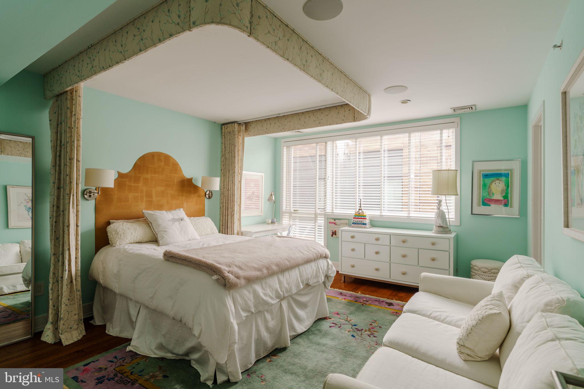 136 North 22nd Street Philadelphia, PA 19103 - Photo 14 of 29 a bedroom with a bed and a chandelier