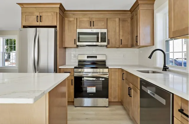 a kitchen with a sink and a stove top oven
