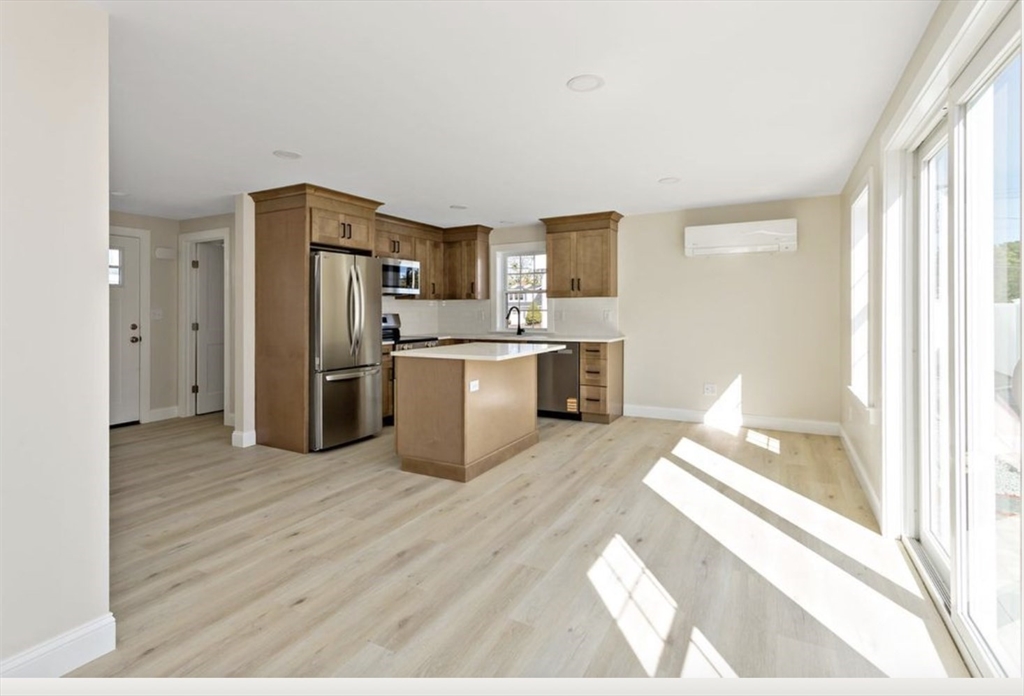 209 Main Street, Unit 1 Dennis, MA 02670 - Photo 17 of 28 a kitchen with stainless steel appliances a refrigerator and a stove top oven