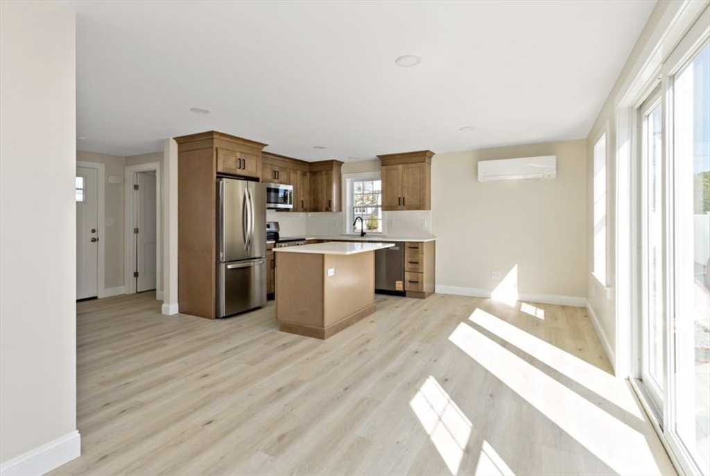 209 Main Street, Unit 1 Dennis, MA 02670 - Photo 18 of 28 a kitchen with stainless steel appliances a refrigerator and a sink