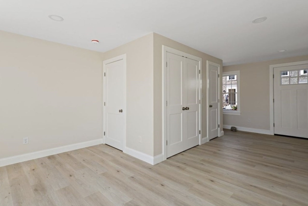 209 Main Street, Unit 1 Dennis, MA 02670 - Photo 21 of 28 a view of an empty room with wooden floor