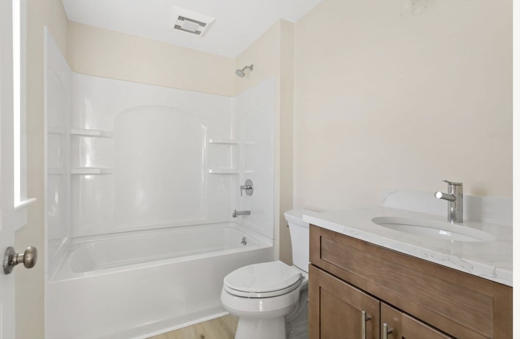 209 Main Street, Unit 1 Dennis, MA 02670 - Photo 25 of 28 a bathroom with a sink a toilet and shower