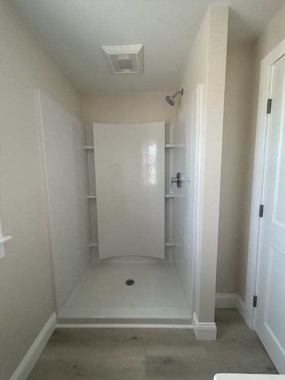 209 Main Street, Unit 1 Dennis, MA 02670 - Photo 26 of 28 a bathroom with a glass shower door