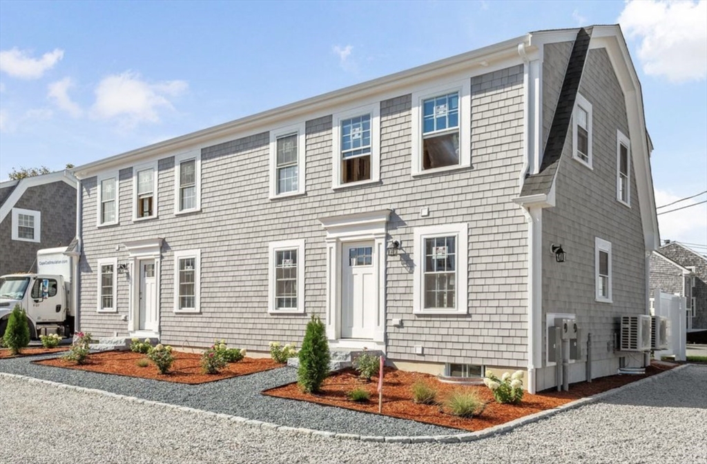 209 Main Street, Unit 1 Dennis, MA 02670 - Photo 4 of 28 a front view of a house with patio