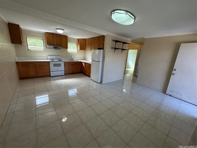a view of a kitchen with a sink and a refrigerator