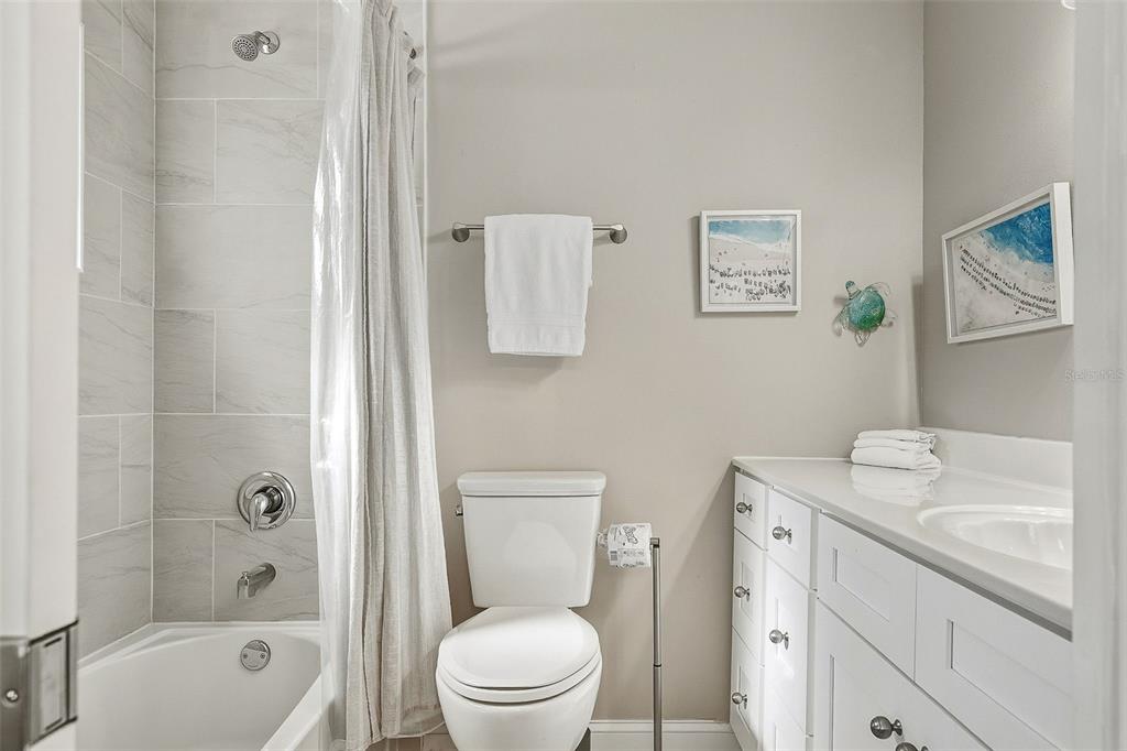 6300 Midnight Pass Road, Unit 21 Sarasota, FL 34242 - Photo 23 of 30 a bathroom with a toilet sink vanity tub and shower