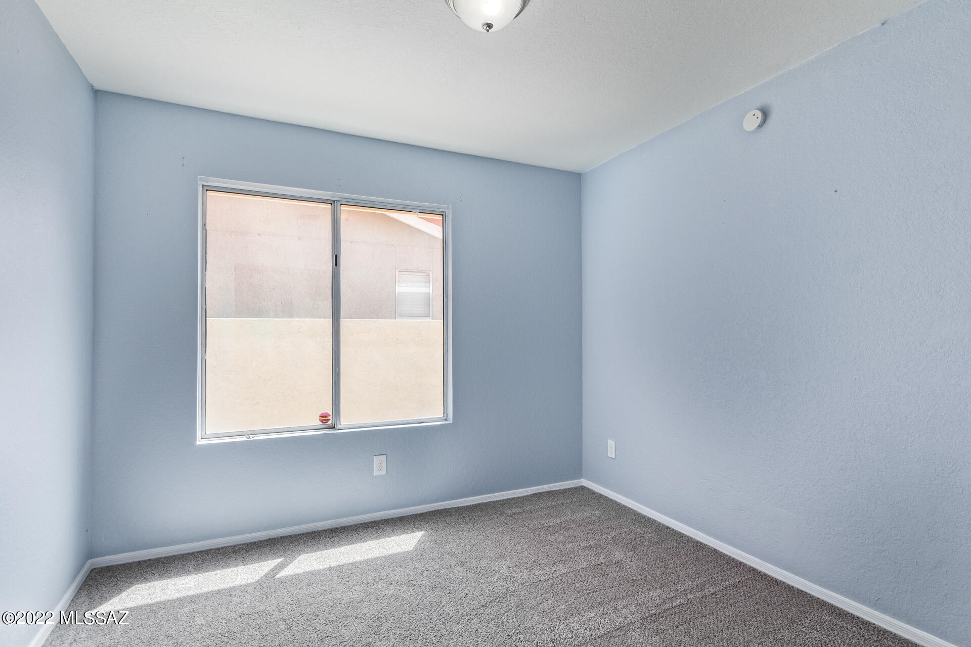4697 West Weathervane Street Tucson, AZ 85741 - Photo 16 of 25 an empty room with a window