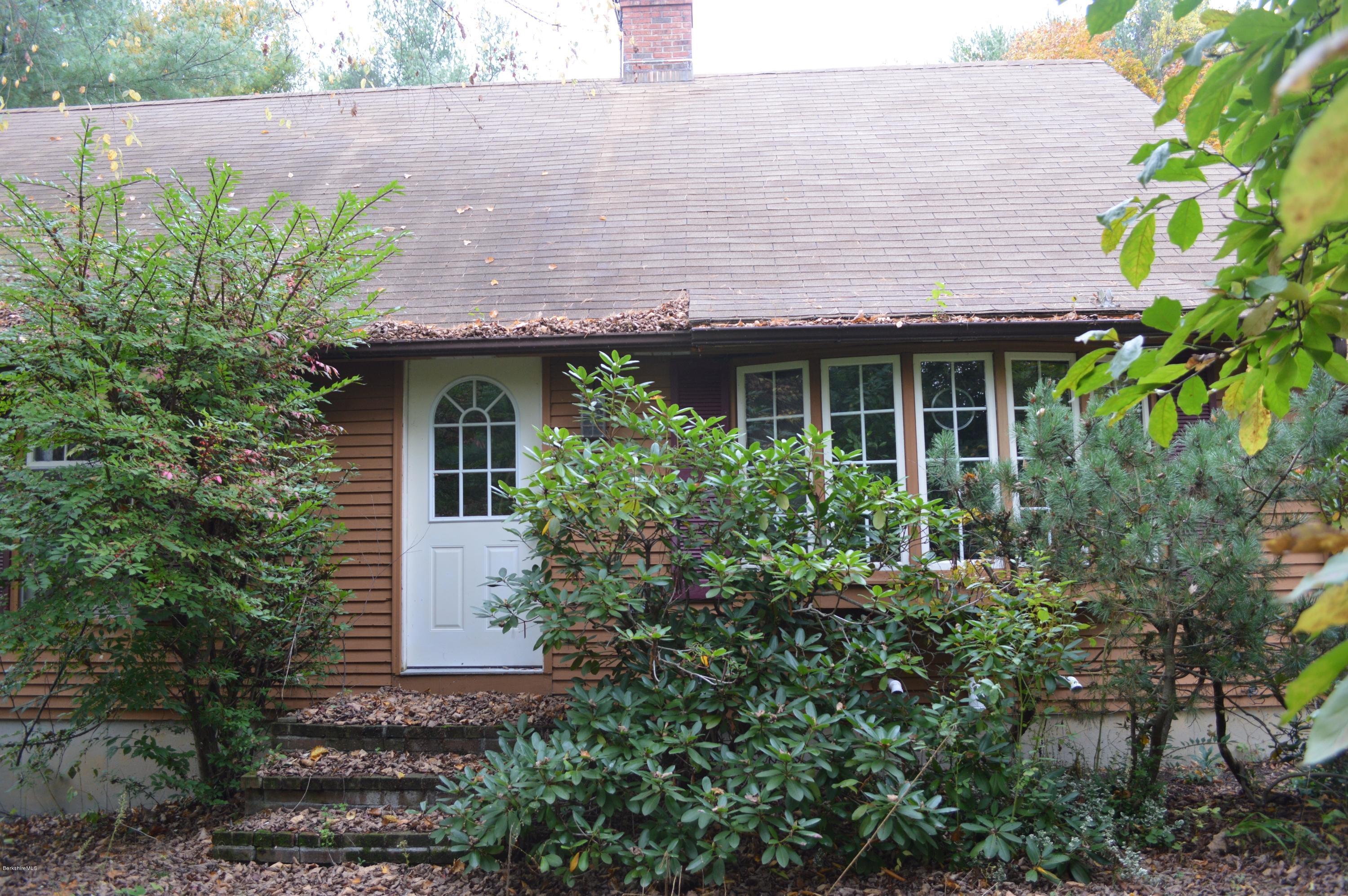 67 Main Road Tyringham, MA 01238 - Photo 2 of 20 a view of a house with plants and a flower garden