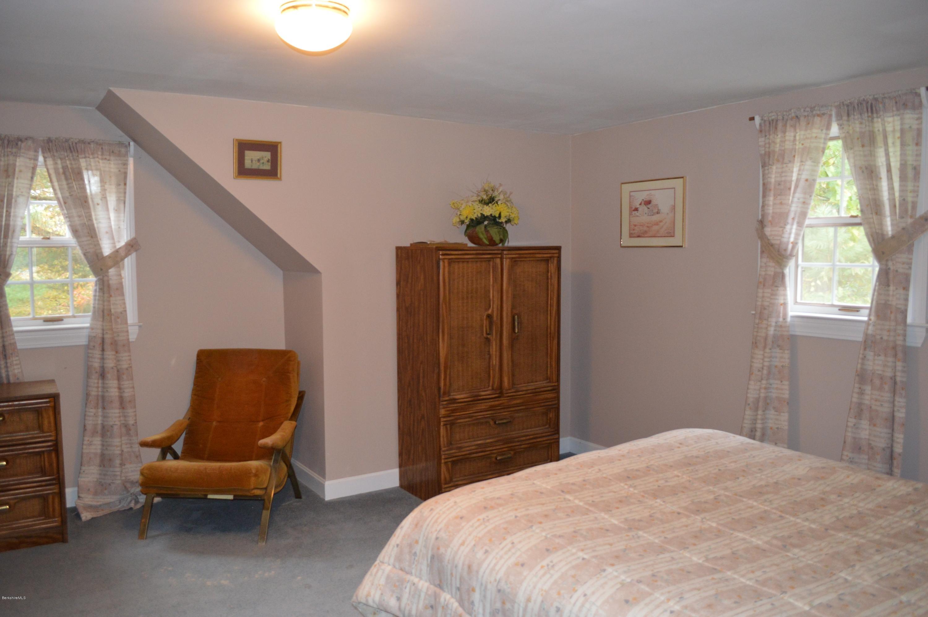 67 Main Road Tyringham, MA 01238 - Photo 15 of 20 a bedroom with a bed and a window