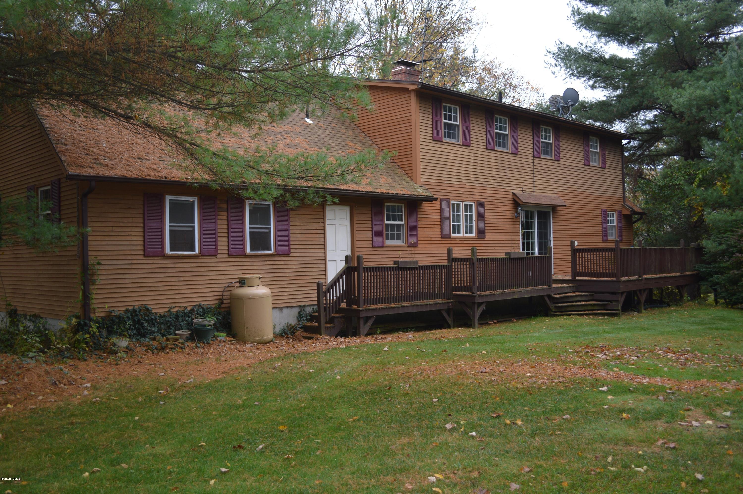 67 Main Road Tyringham, MA 01238 - Photo 19 of 20 a view of a backyard with plants and a barbeque